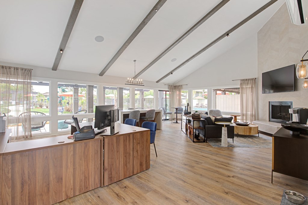 a large management office with large windows, couches, desks, and computers