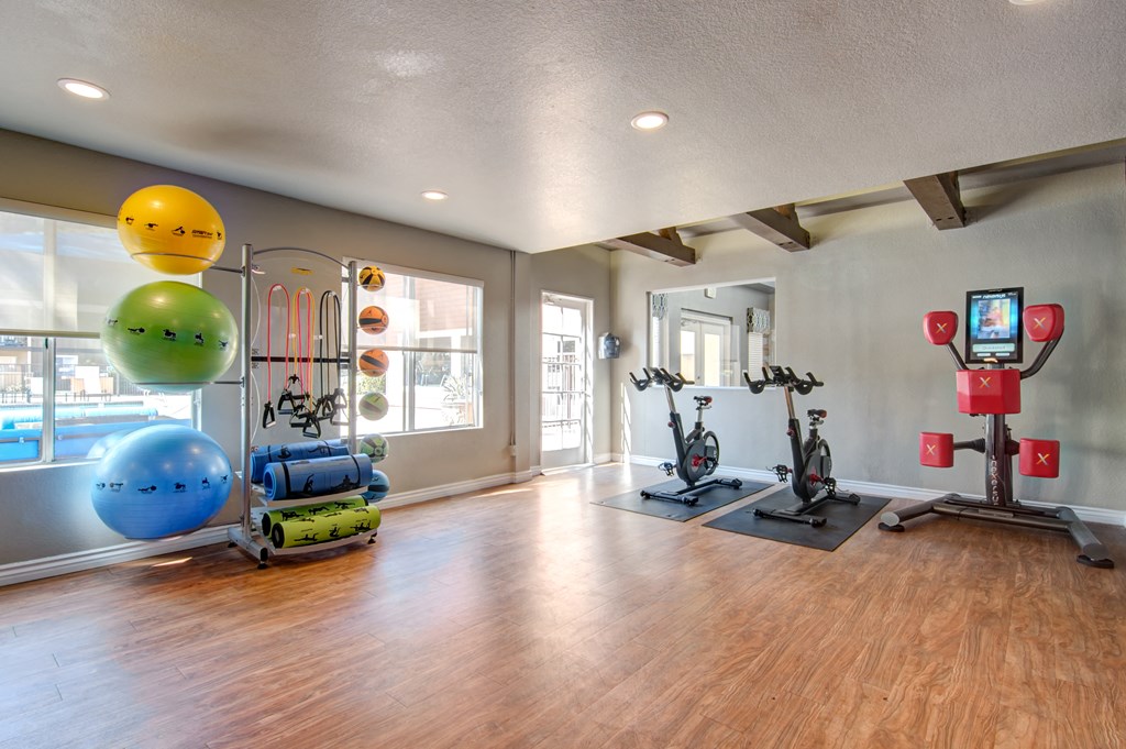 a workout room with weights and other exercise equipment at 1861 muleshoe road apartments