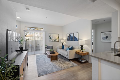 A modern living room with a white sofa and a wooden coffee table.