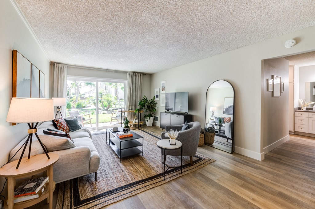 a living room with a couch and a chair and a tv