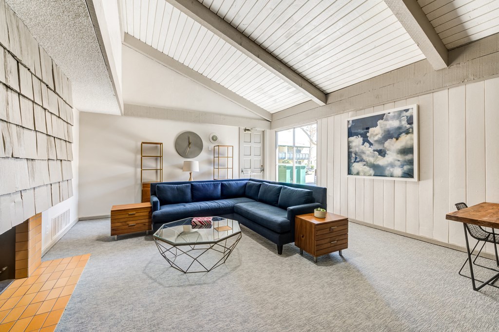 a living room with a blue couch and a coffee table