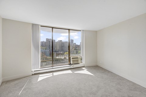 a living room with a large window and a view of the city