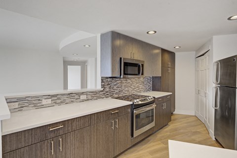 a kitchen with wooden cabinets and stainless steel appliances