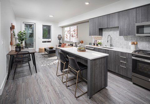 A modern kitchen with a dining table and chairs.
