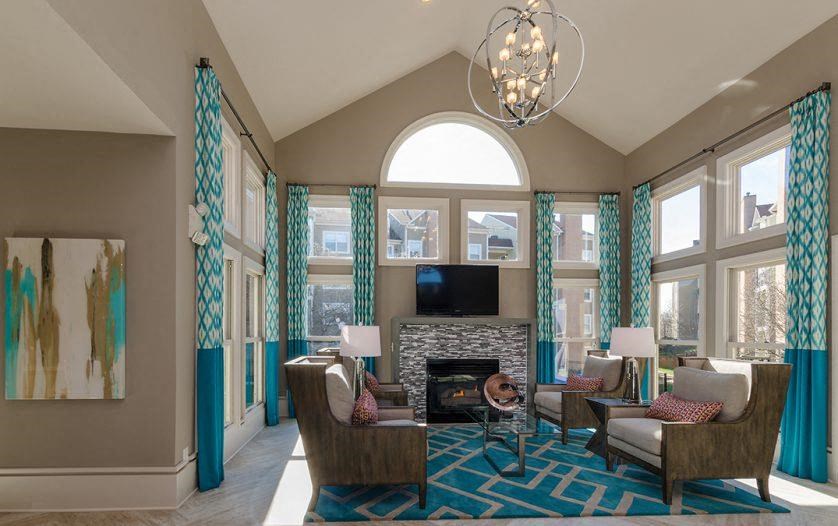 a living room with couches and chairs and a fireplace
