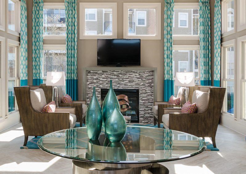 a living room with a table and chairs and a television