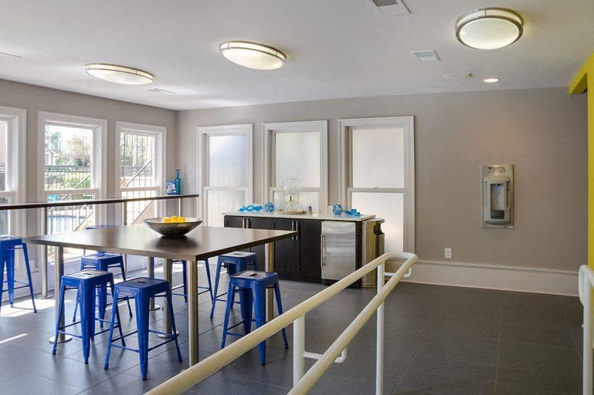 a room with a table and chairs and a railing