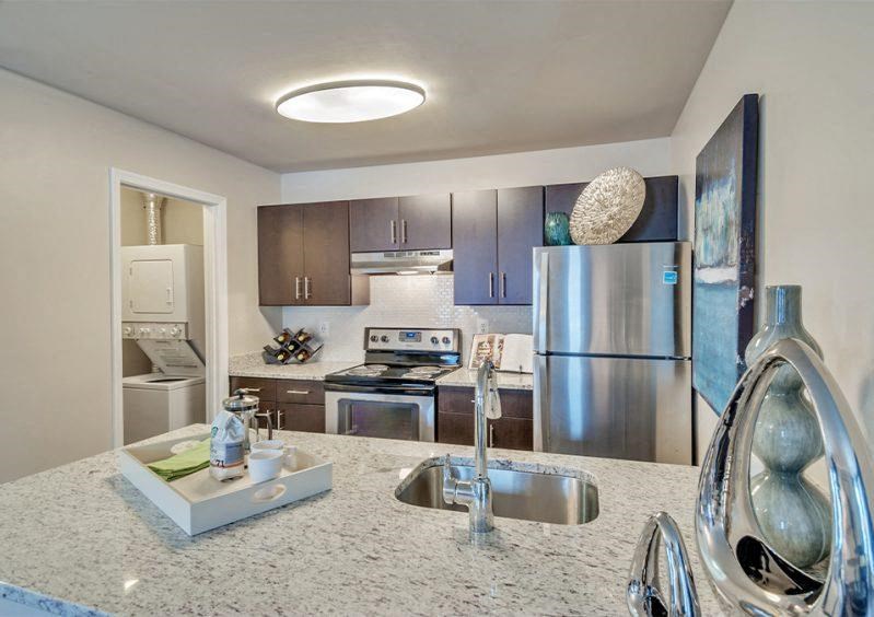 a kitchen with stainless steel appliances and a granite counter top