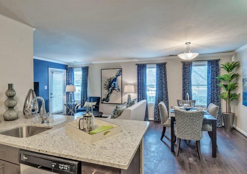 a kitchen and living room with a table and chairs