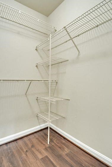 a wire rack on the wall of a closet