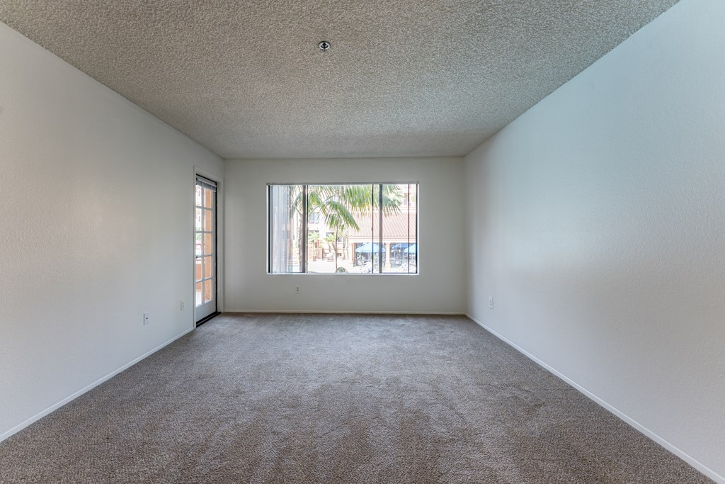 an empty living room with a large window