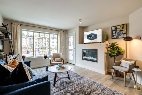 a living room with a fireplace and a large window