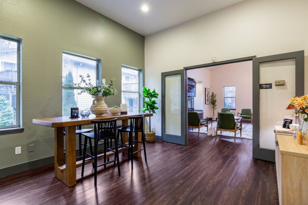 A dining room with a wooden table and chairs.