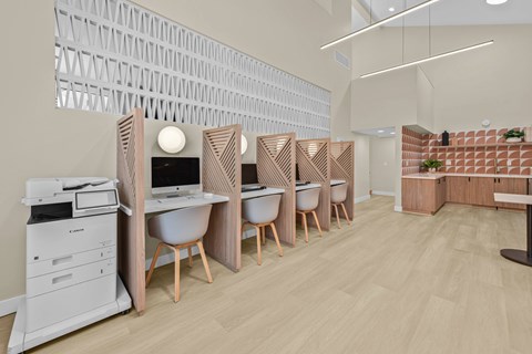 A modern office space with wooden furniture and a white printer.