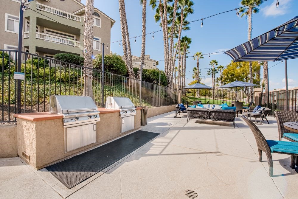 A pool area with sun loungers and a hot tub.