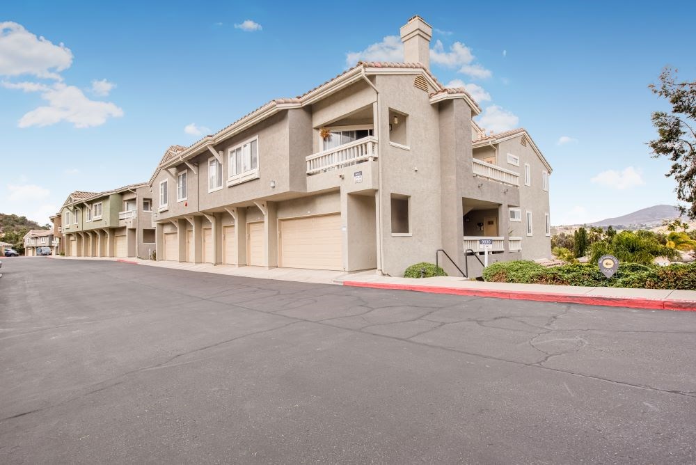 A row of houses with a clear blue sky above them.
