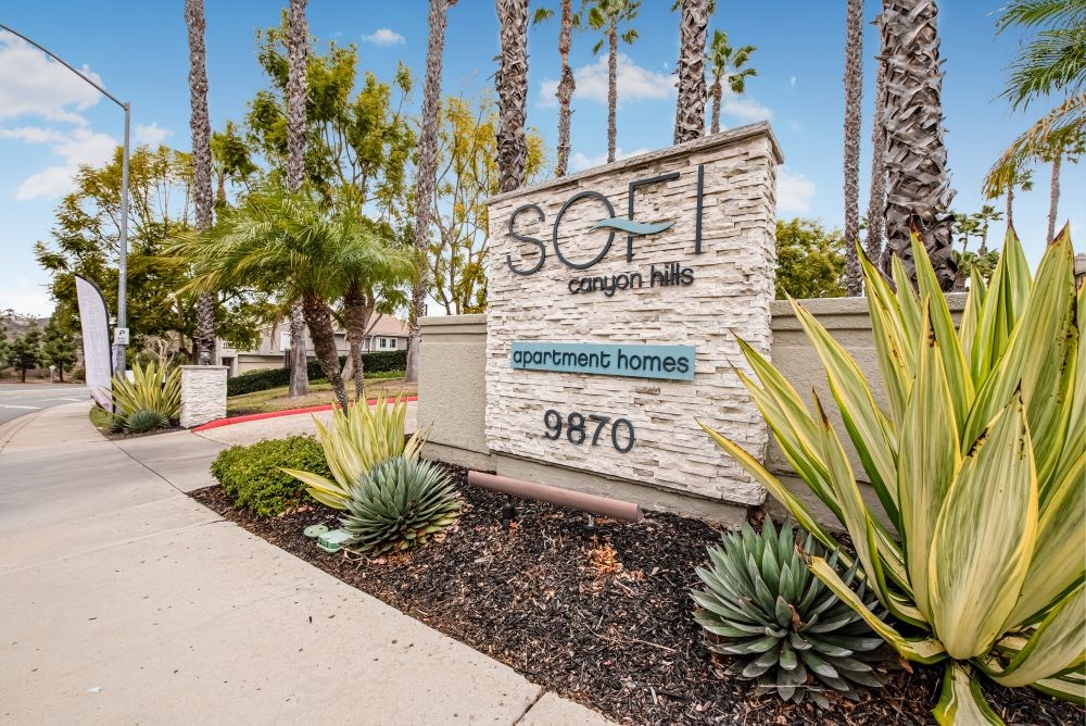 A sign for SoFi Canyon N.I.L.S. with a palm tree in the background.