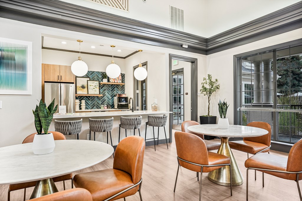 A modern dining room with a round table and chairs.