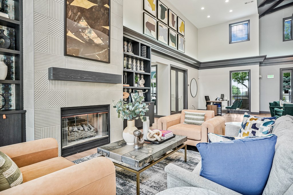 A living room with a fireplace and a painting on the wall.