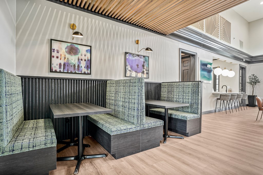 A room with a wooden ceiling and a green chair.
