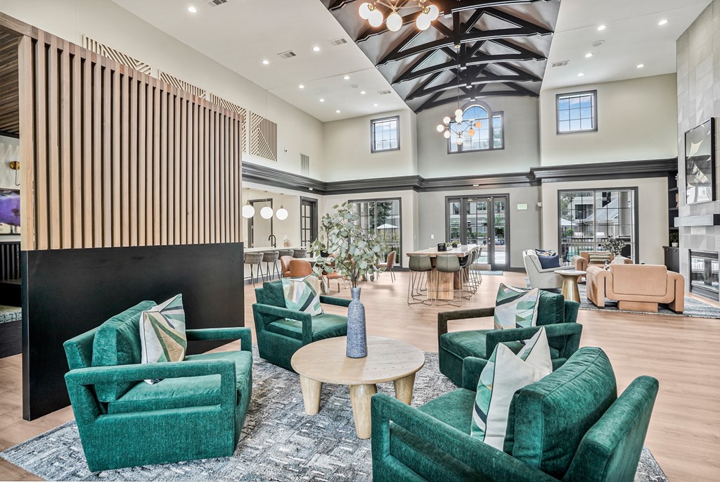 A large room with green chairs and a wooden partition.