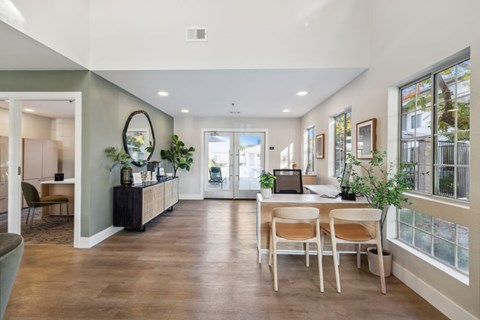A modern dining room with a wooden table and chairs.