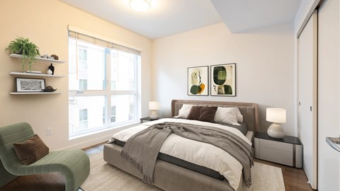 A bedroom with a large bed and a green chair.