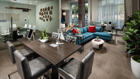 A modern dining room with a wooden table and black leather chairs.