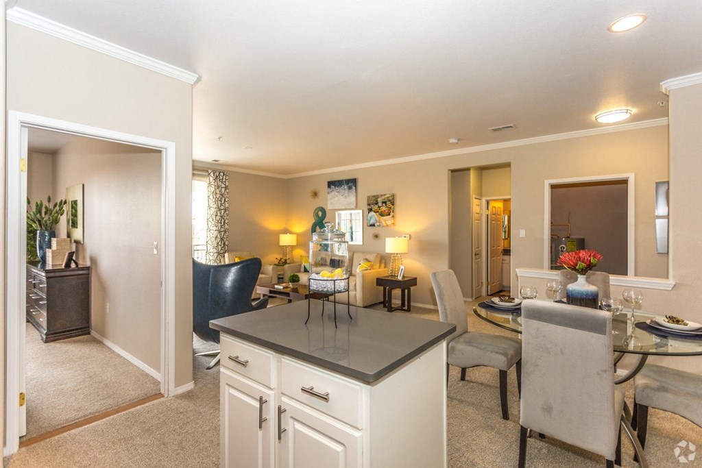 a living room with a kitchen and a dining room