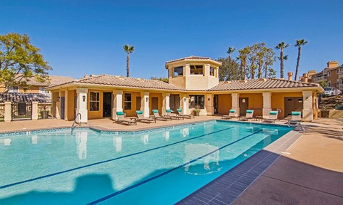 a swimming pool with a house in the background