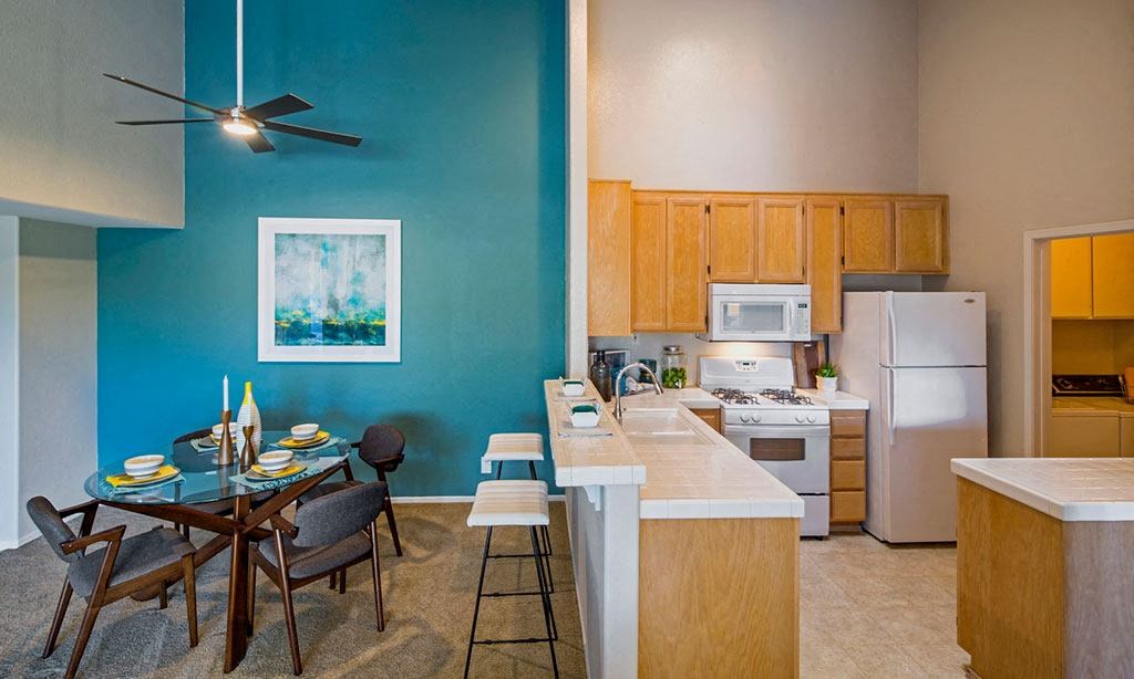 a kitchen and dining room with a table and chairs
