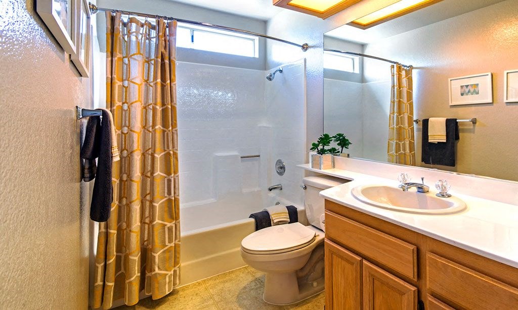 a bathroom with a shower toilet and sink