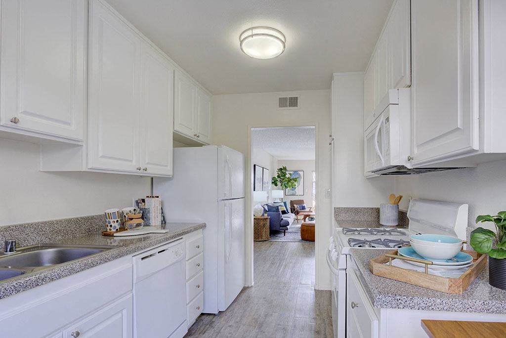 a kitchen with white cabinets and a sink