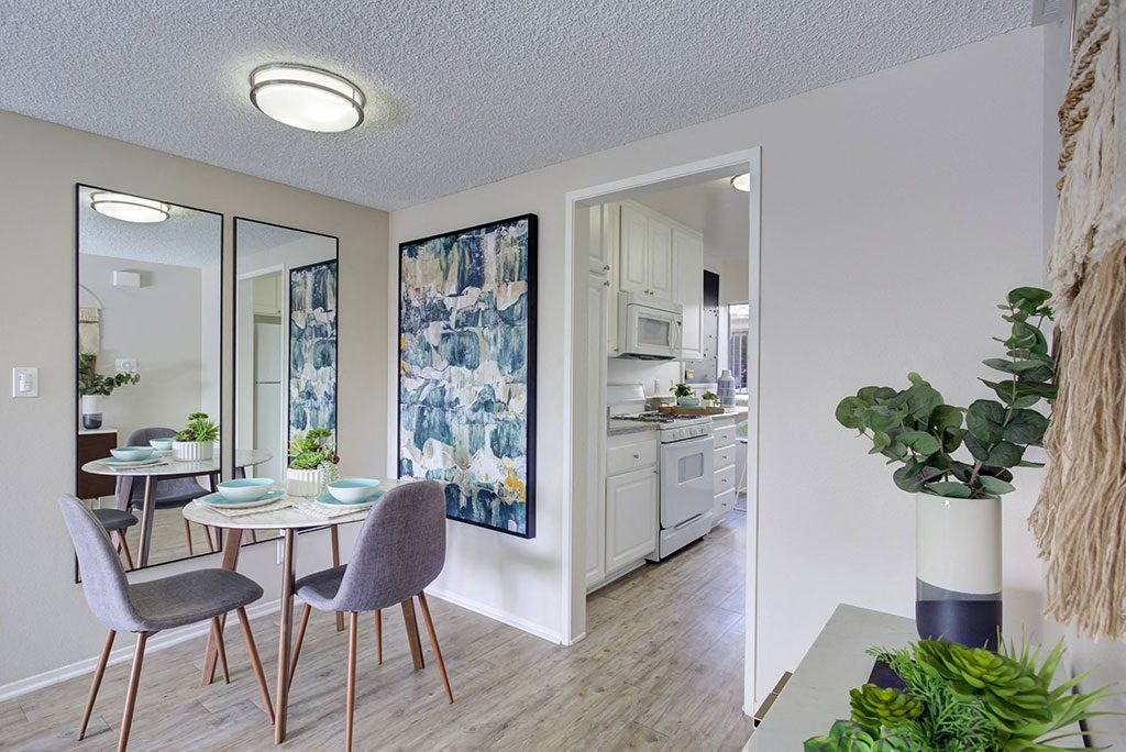 an open dining room and kitchen with a table and chairs