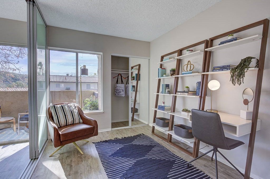 a living room with a chair and a window