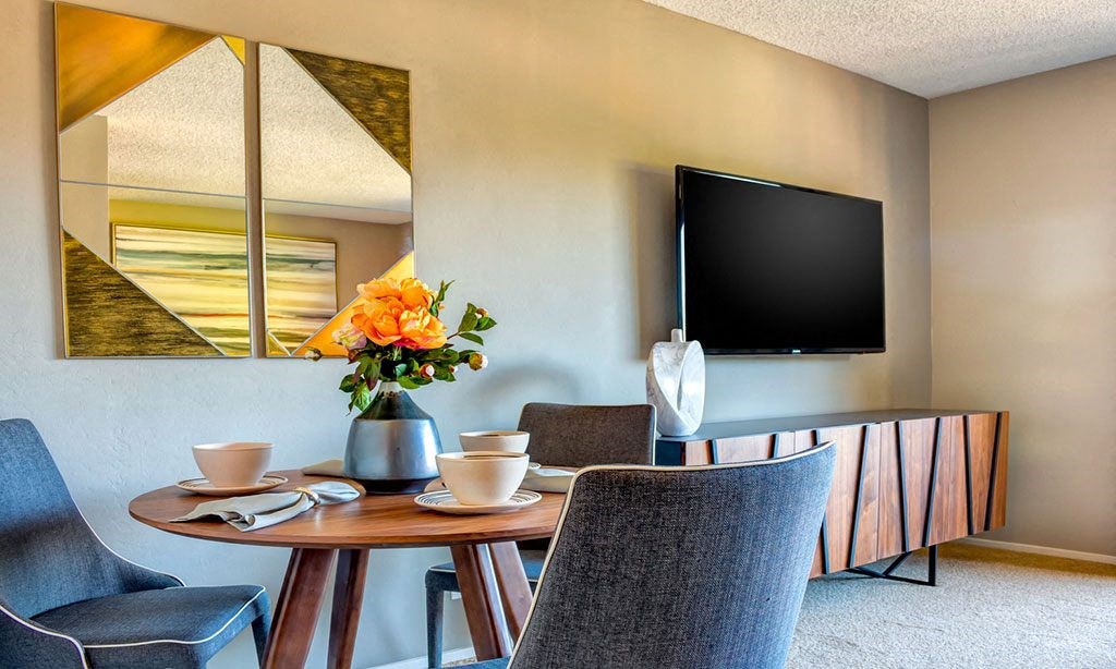 a dining room with a table and chairs and a television