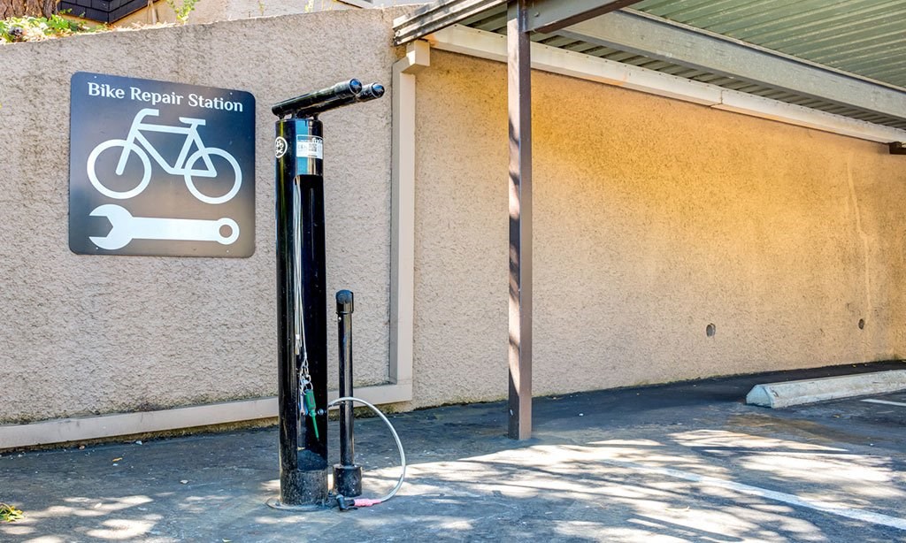 a bike repair station sign on the side of a building