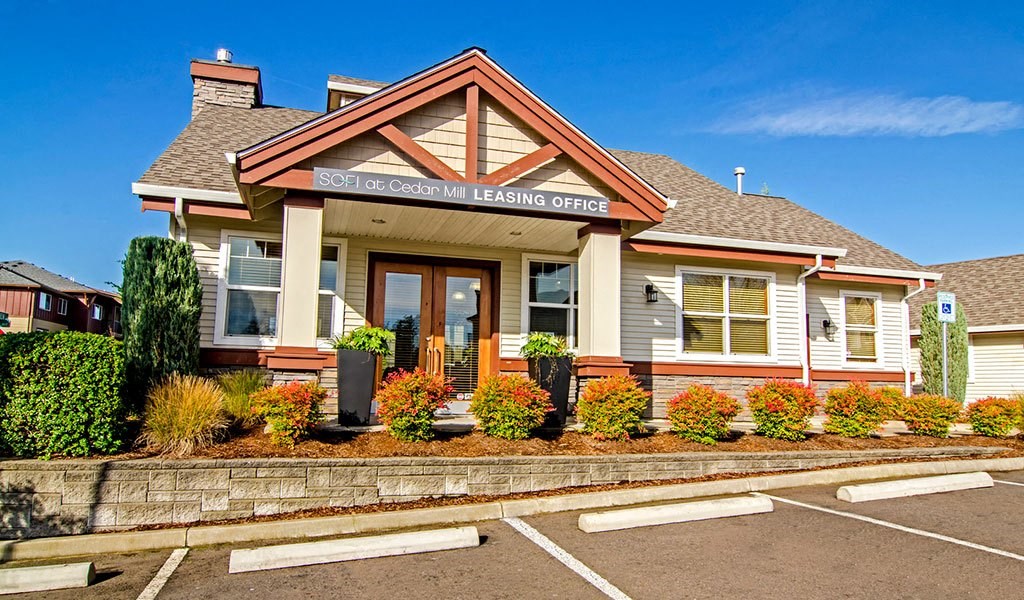 the front of a building with a parking lot