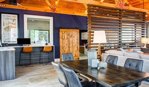 a living room and dining room with a table and chairs