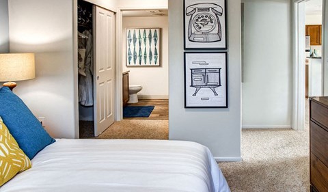 a bedroom with a bed and a door to a bathroom