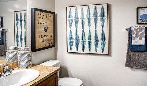 a bathroom with a sink toilet and a mirror