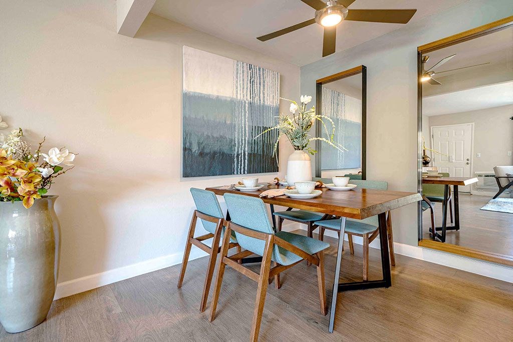 a dining room with a wooden table and chairs
