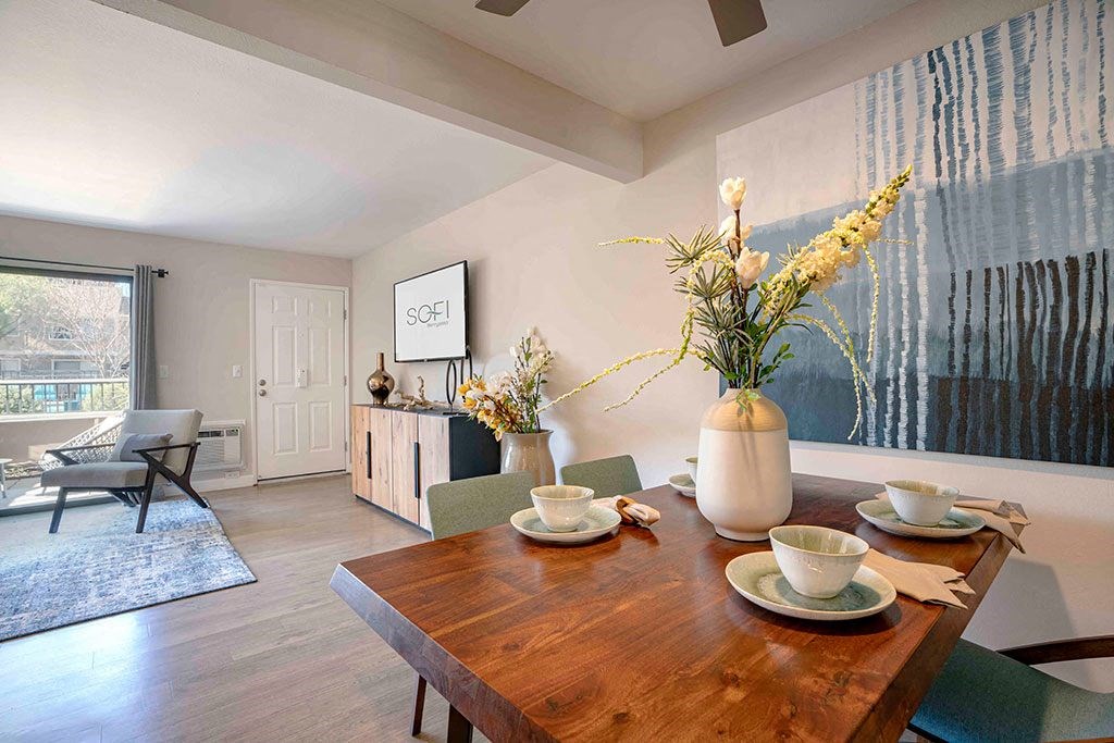 a dining room with a wooden table and chairs