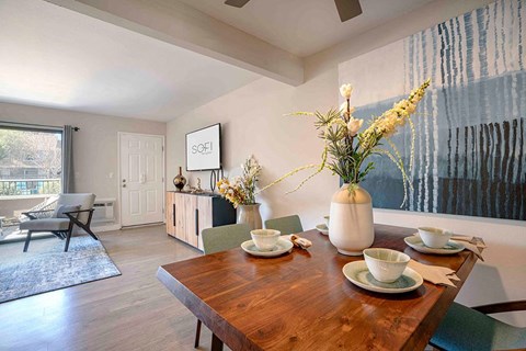 a dining room with a wooden table and chairs