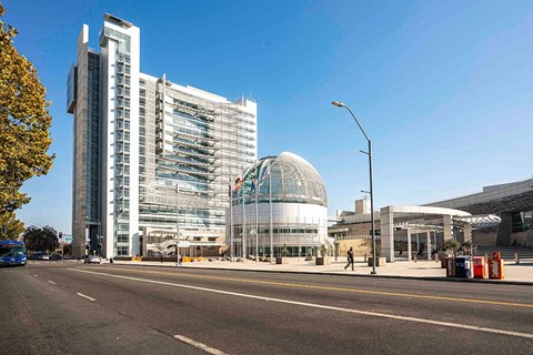 a view of a city street and a building with a glass dome