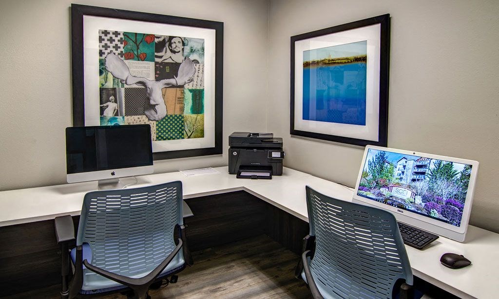a conference room with two computers and two chairs
