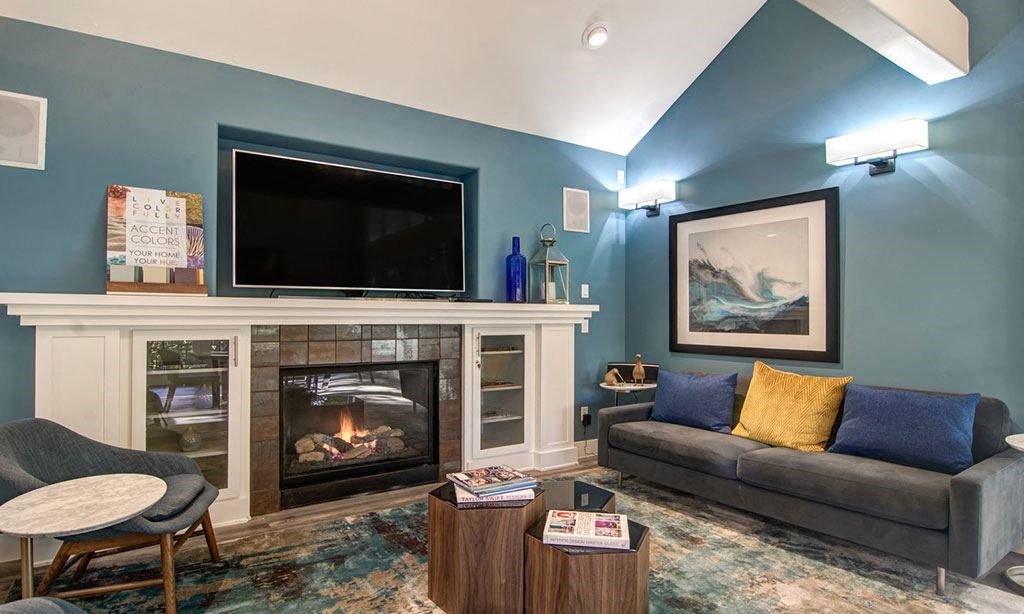 a living room with a fireplace and a television