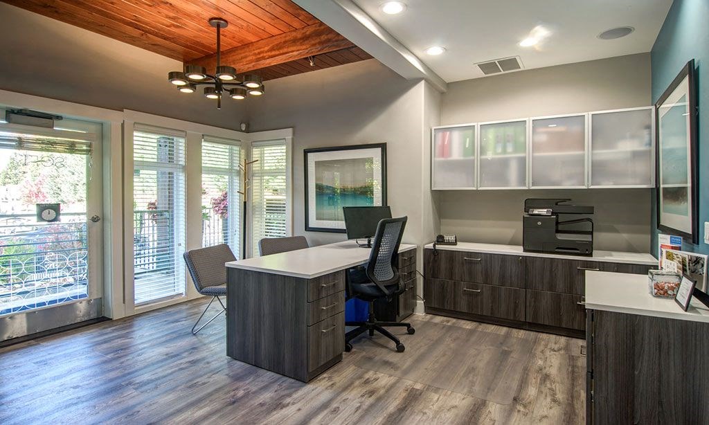 a home office with a desk and a window