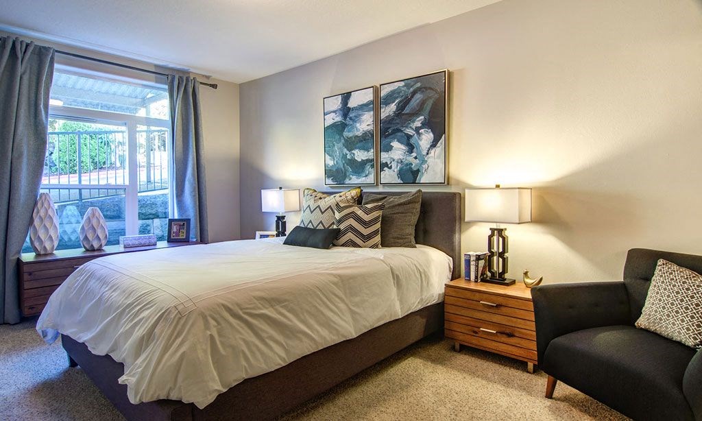 a bedroom with a bed and a window