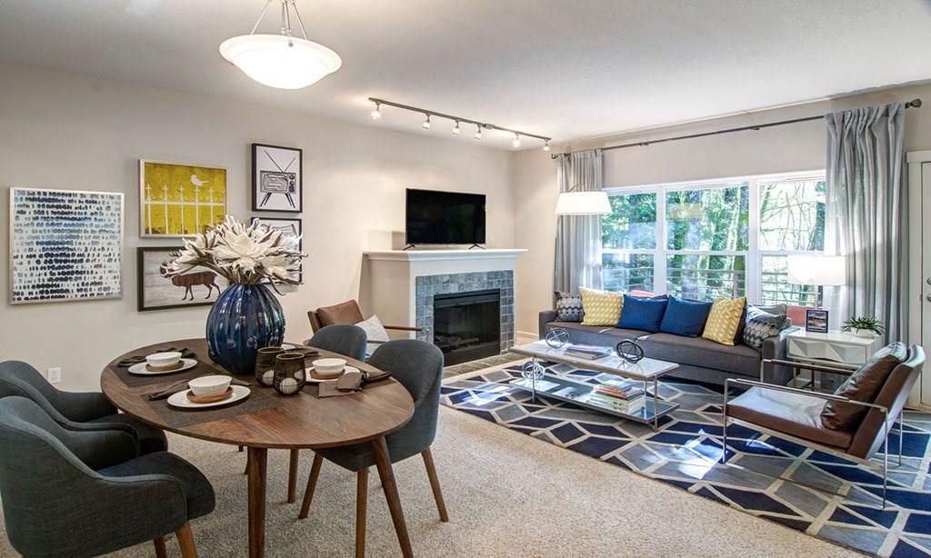 a living room with a fireplace and a table